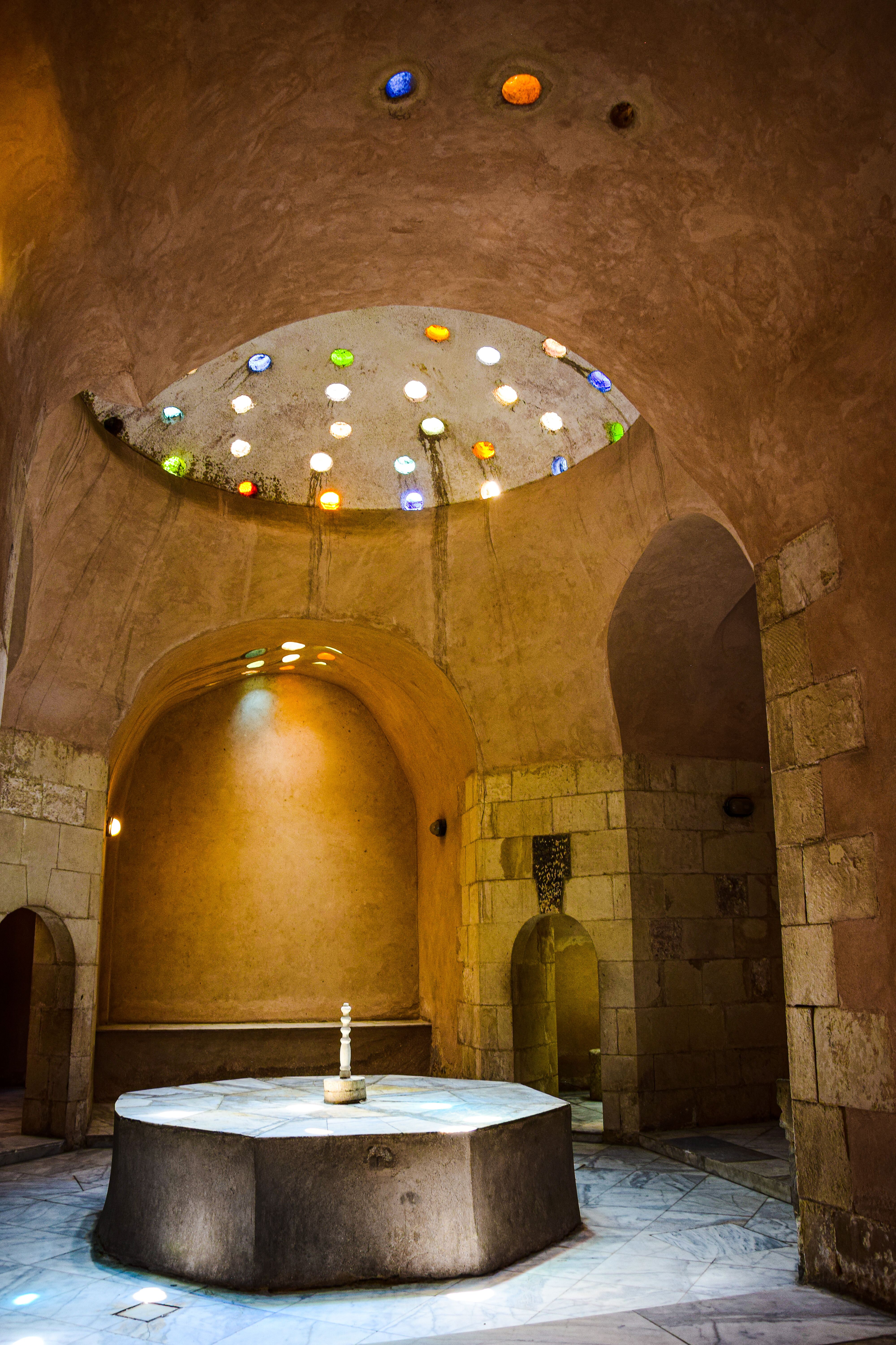 Domed ceiling of a historic Istanbul hammam with glass oculi
